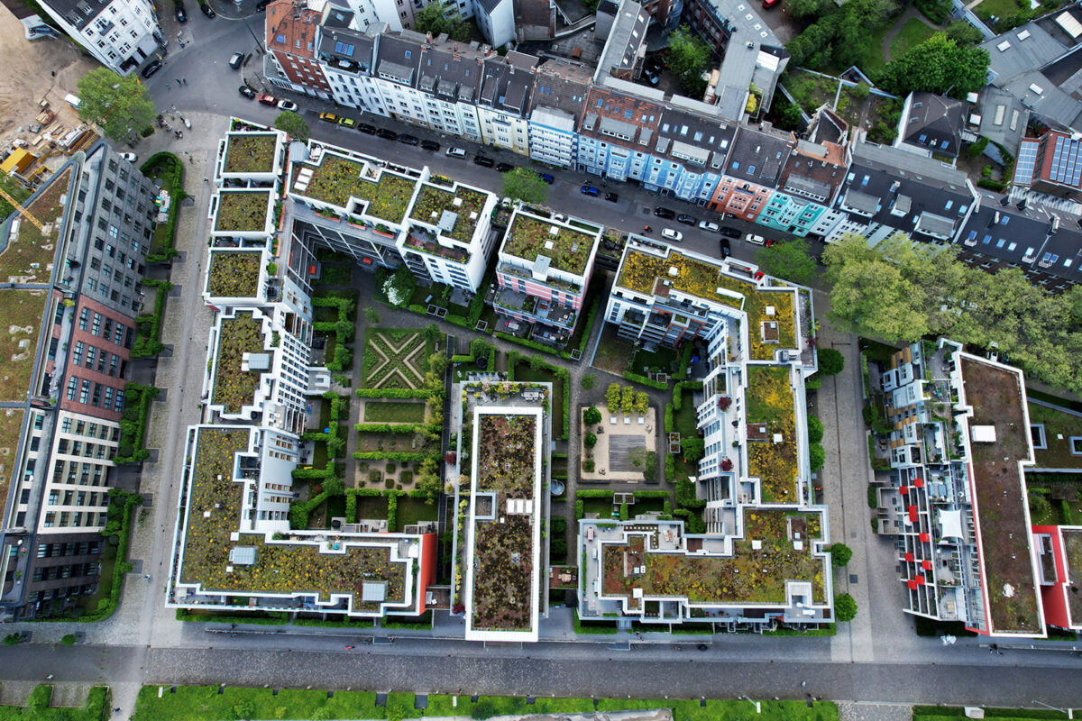 aerial view of innovating roofing trends like green roofs and solar panels